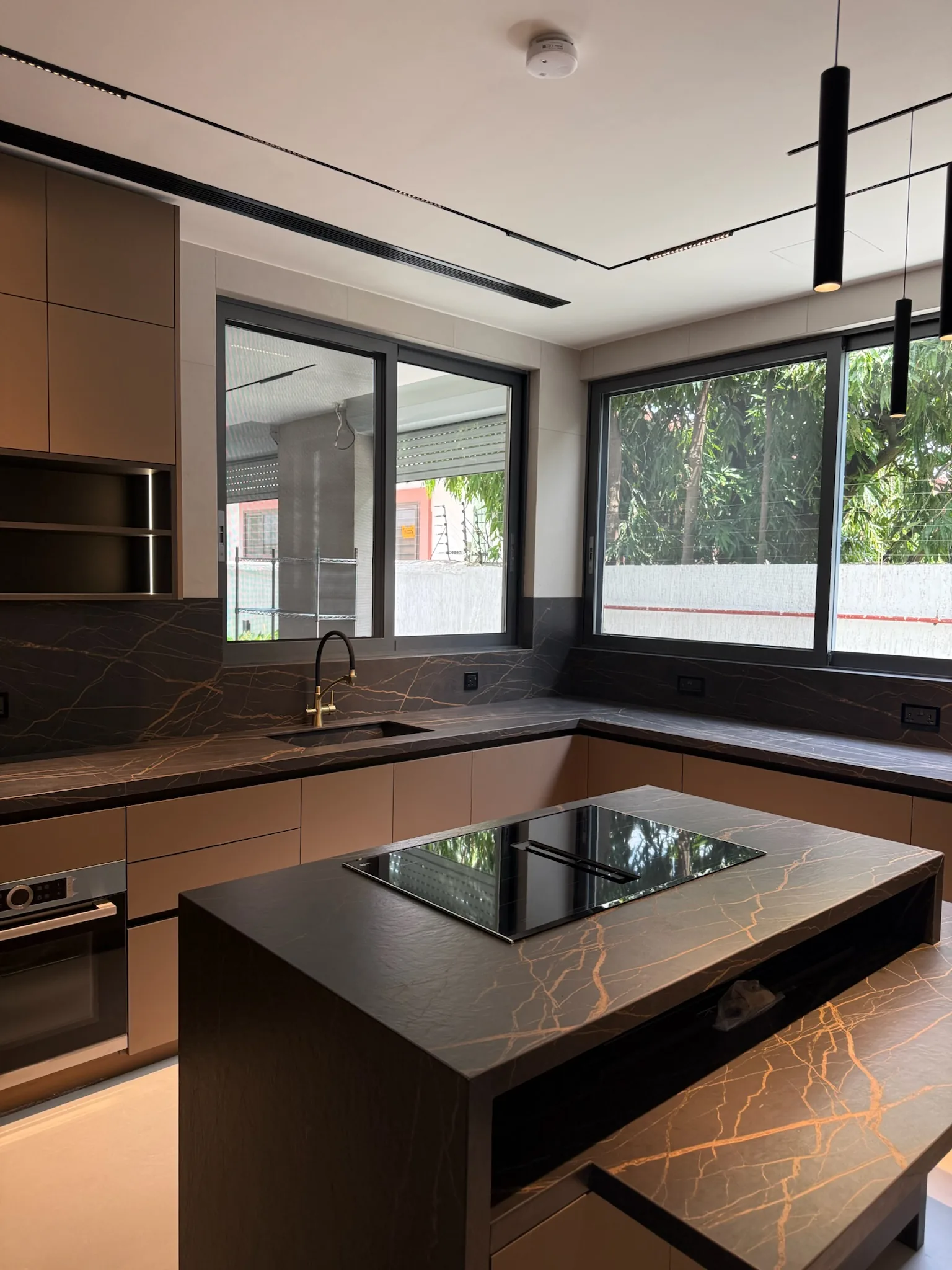 Enzo Living kitchen — sintered stone island and bespoke cabinetry, Accra
